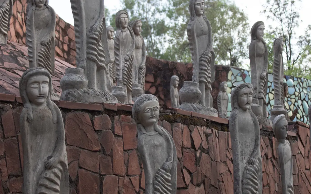 Stone figure sculptures along a wall at the Rock Garden in Chandigarh